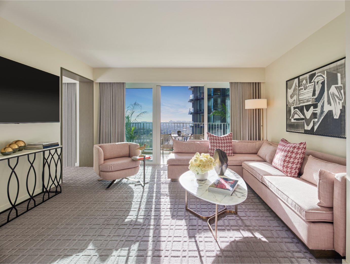 The seating area and furnished balcony of the Producers Suite at Fairmont Century Plaza.