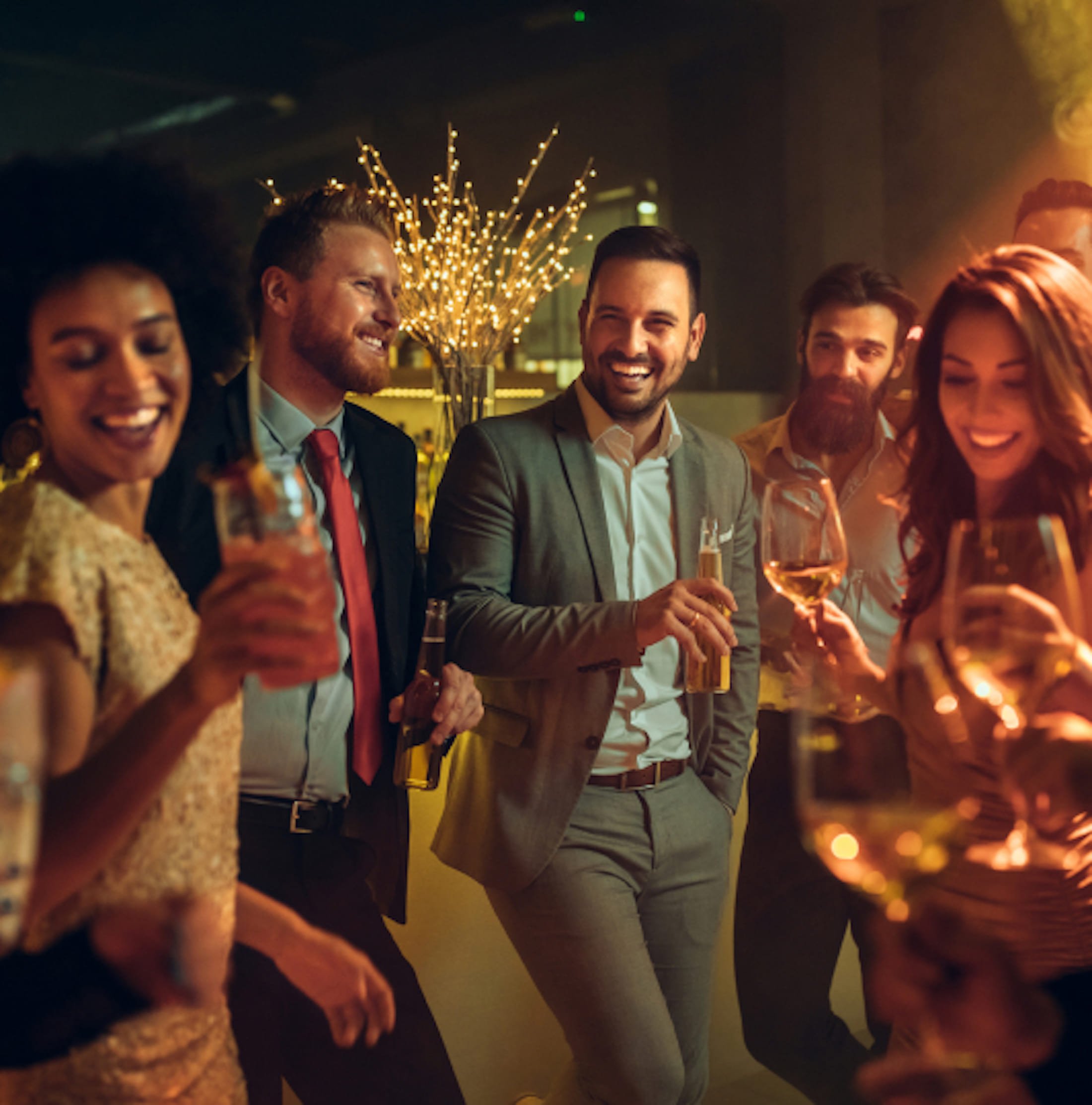 A group of people drinking and laughing.