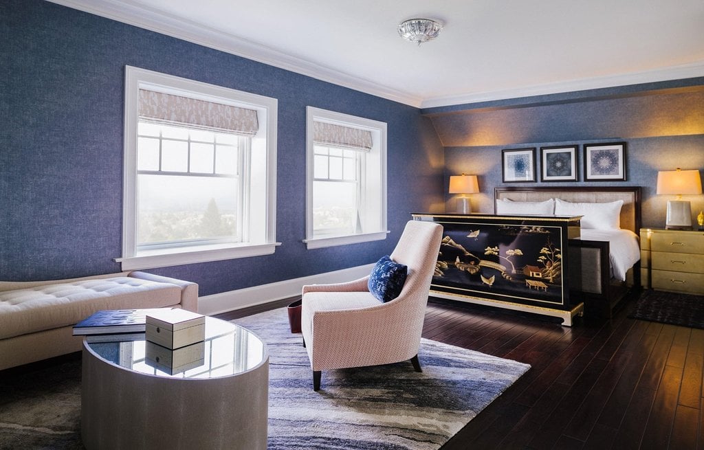 The bedroom and seating area of the Presidential Bayview One Bedroom Suite at Claremont Club & Spa.