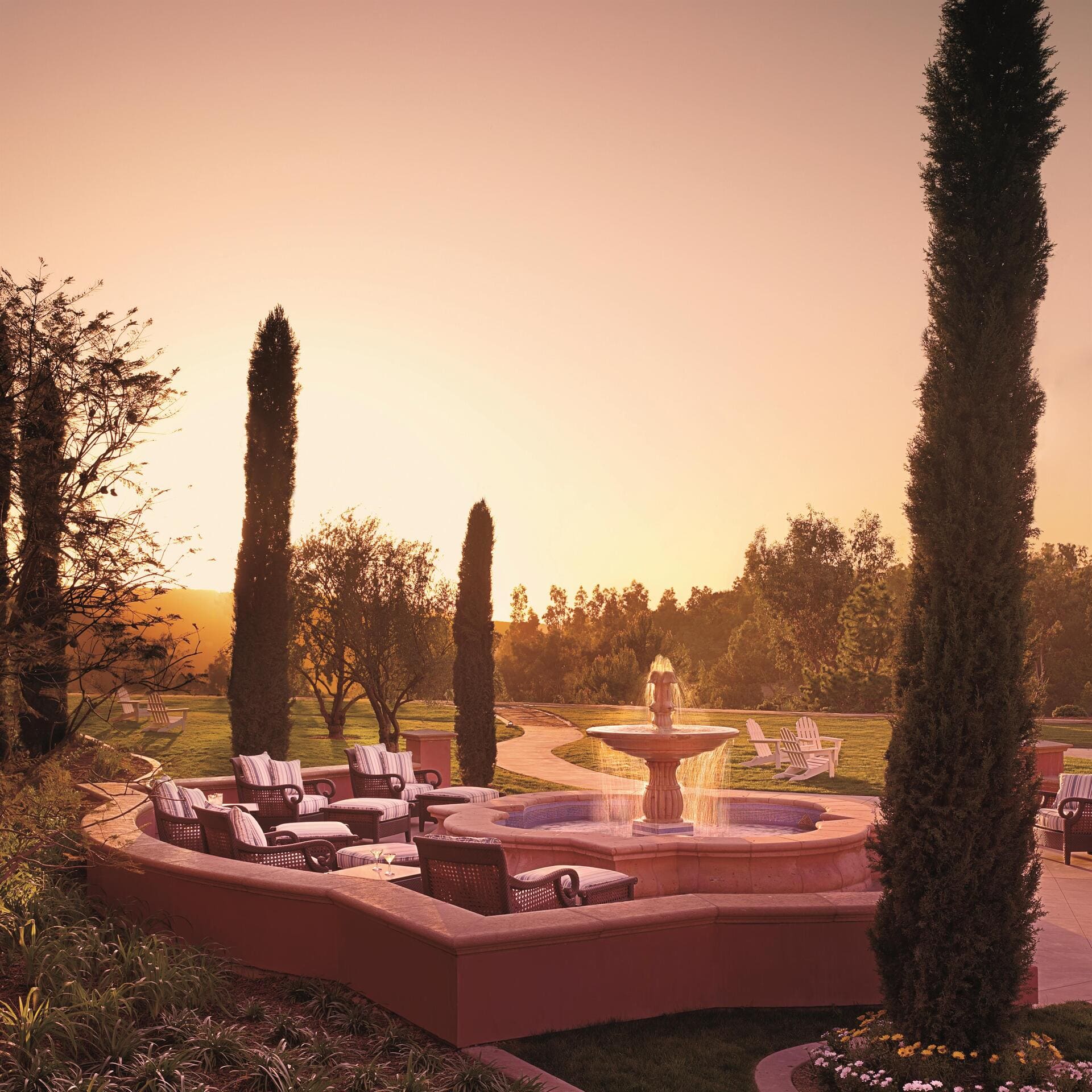 A stone fountain in a courtyard at sunset, at Fairmont Grand Del Mar.