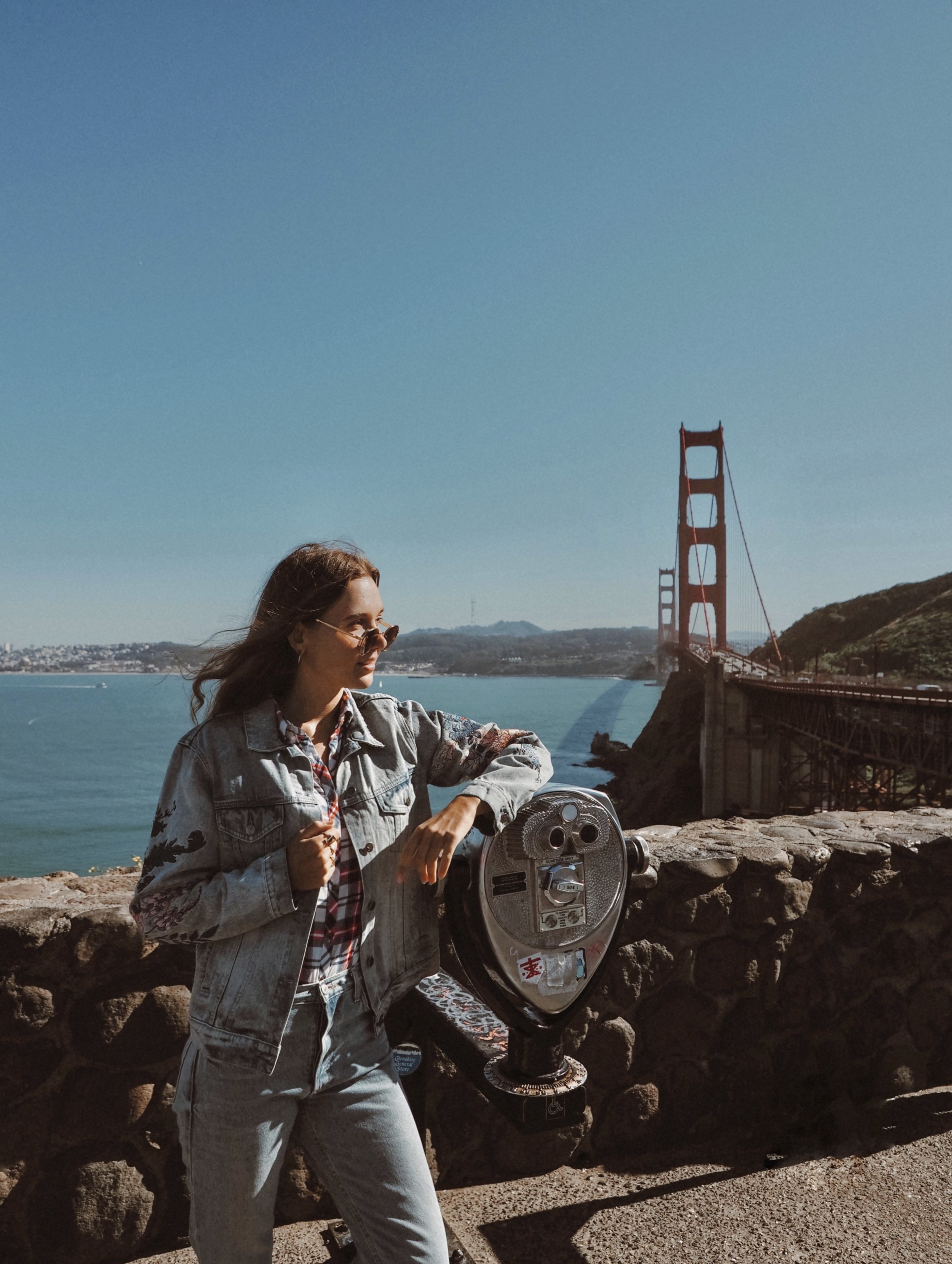 A woman at a lookout point near the Golden Gate Bridge.