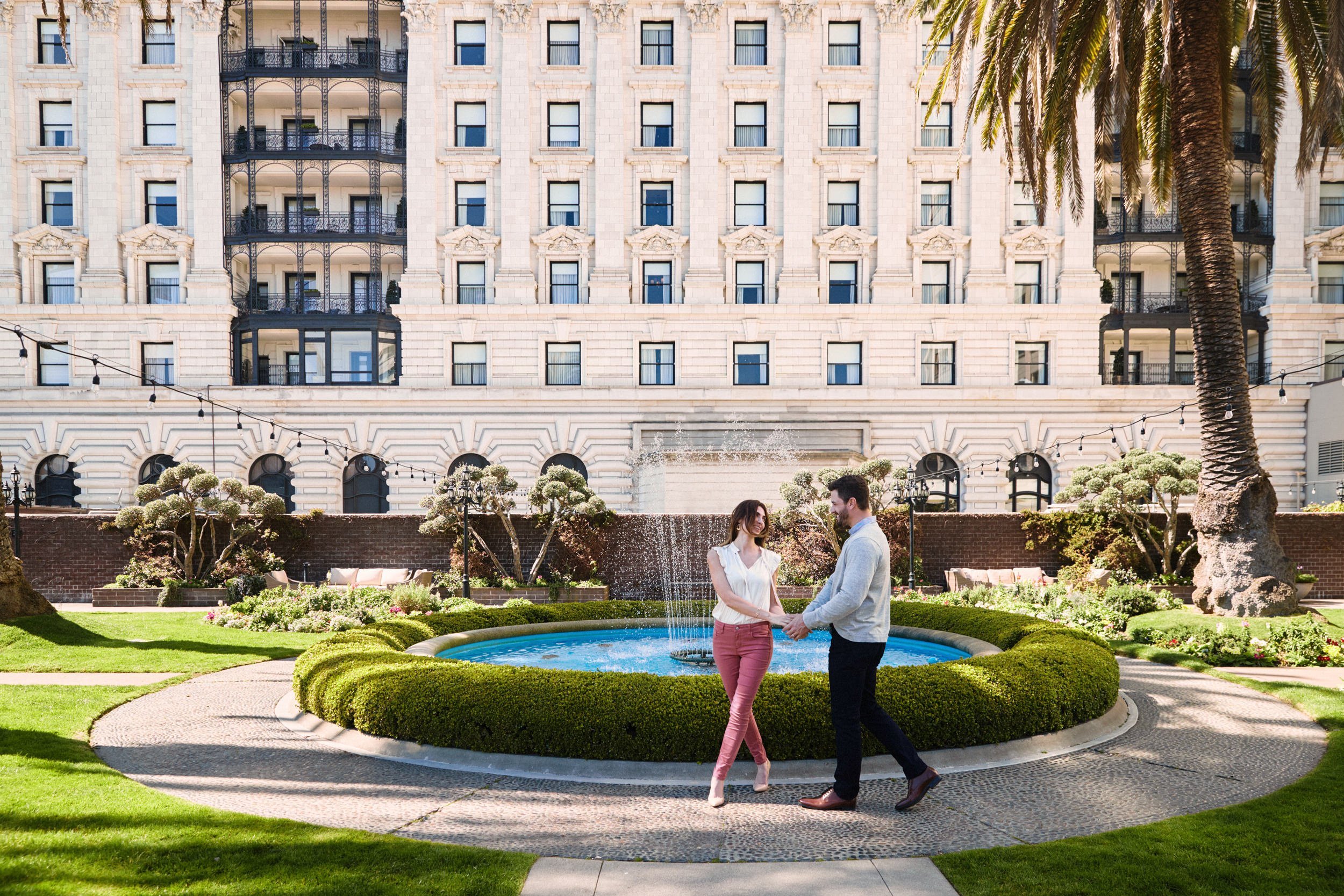 A couple in a sunny garden.