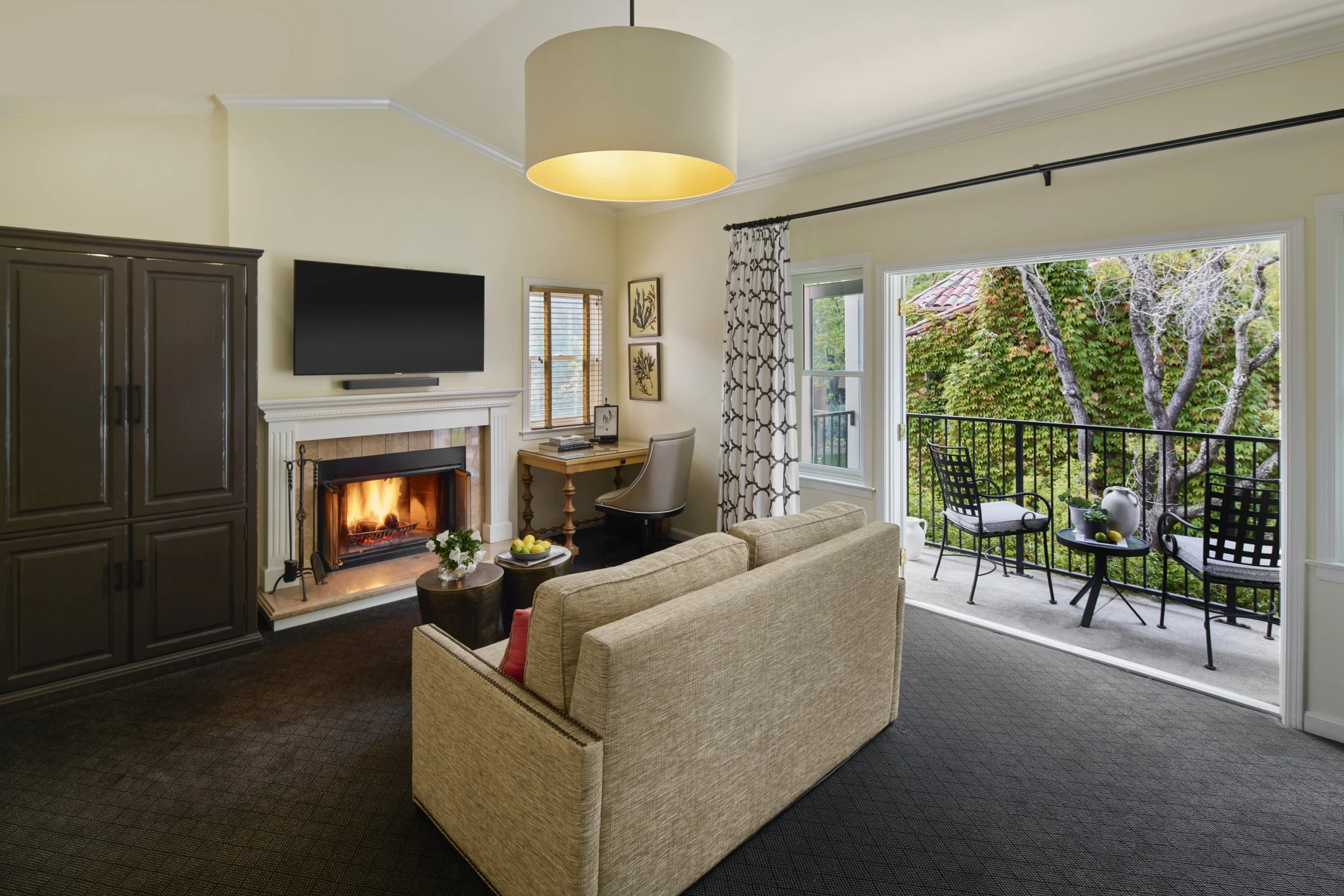 The seating area with fireplace and the furnished balcony of the Vineyard Suite at Fairmont Sonoma.