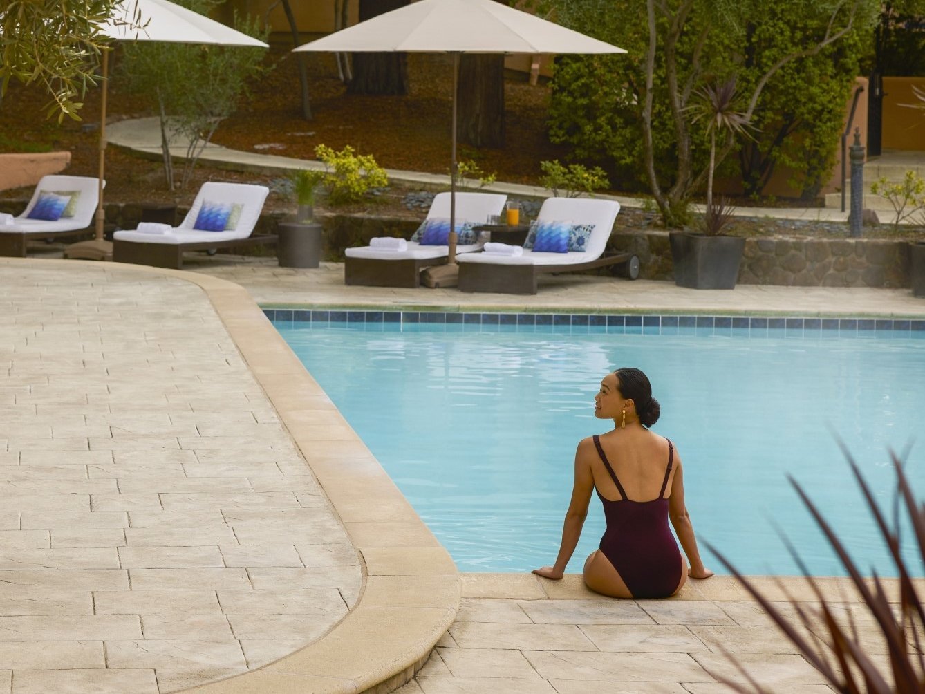 Woman sitting on edge of pool at Fairmont Sonoma.